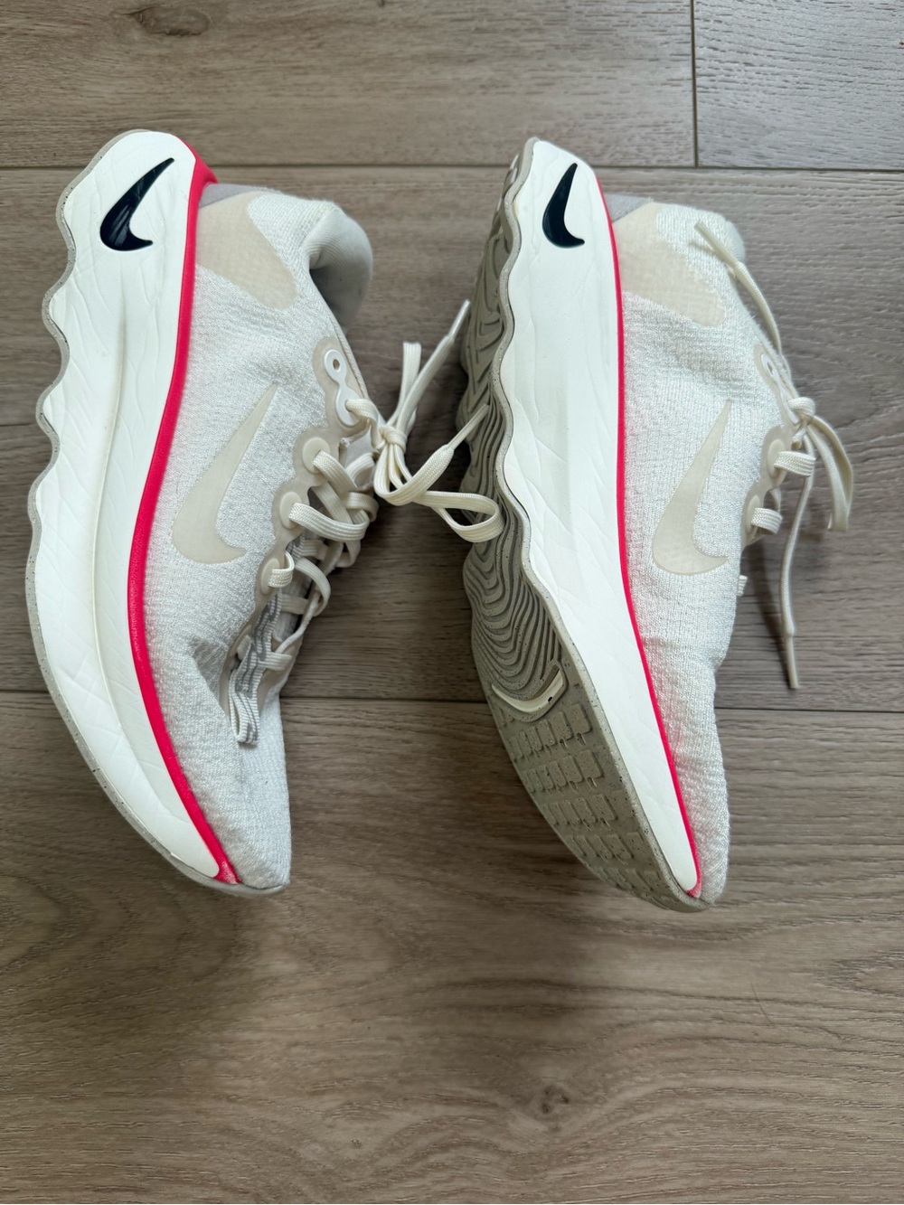 Nike Women's Cream Running Sneakers with Pink Trim and Black Swoosh